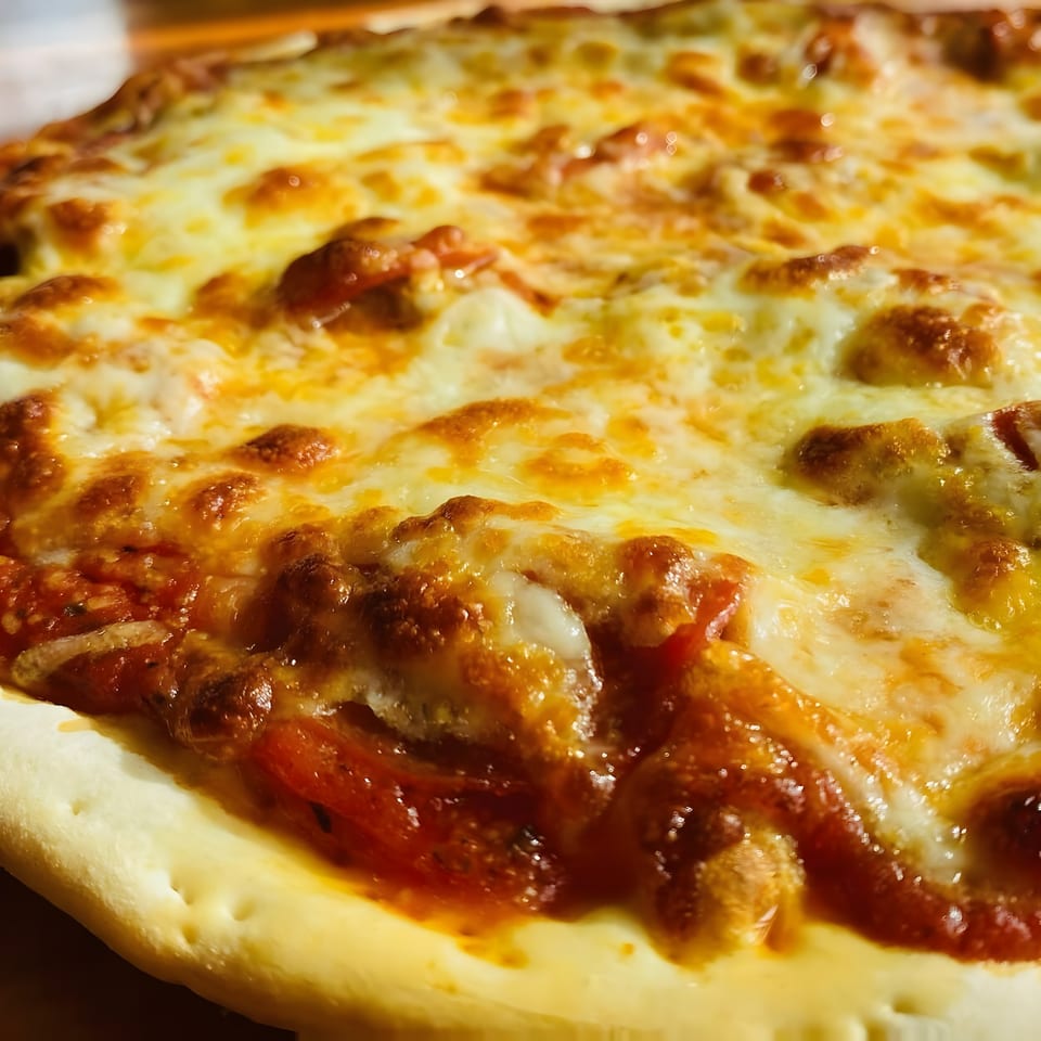 Close-up of a Bada Bing Pizzeria pizza, featuring melted cheese and rich tomato sauce.